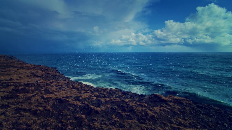 Rocky Cliff Overlooking Ocean — Blue, Dramatic