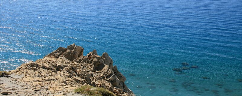 Rocky Cliff Overlooking Sea — Blue