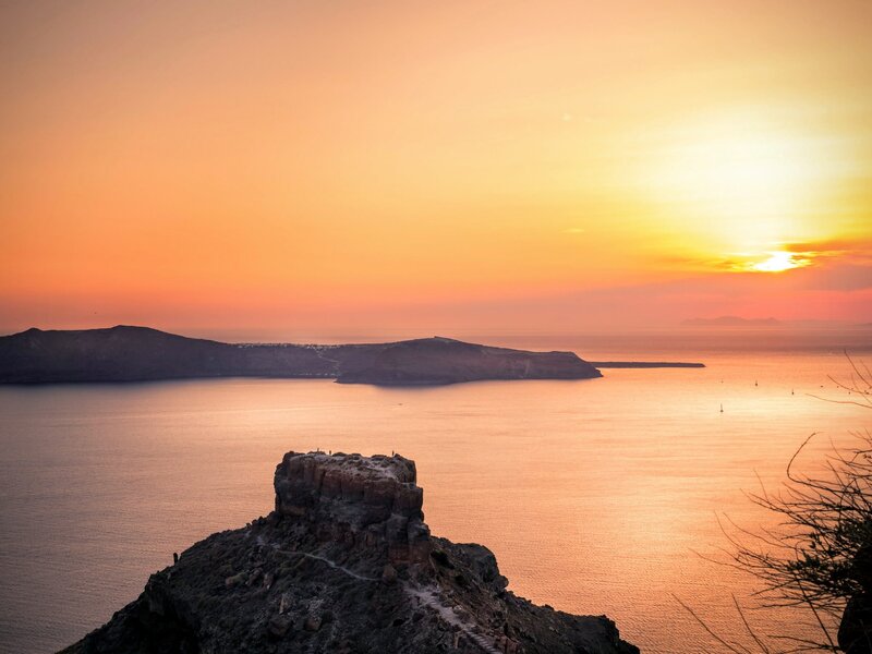 Rocky Cliff Overlooking Sea — Orange