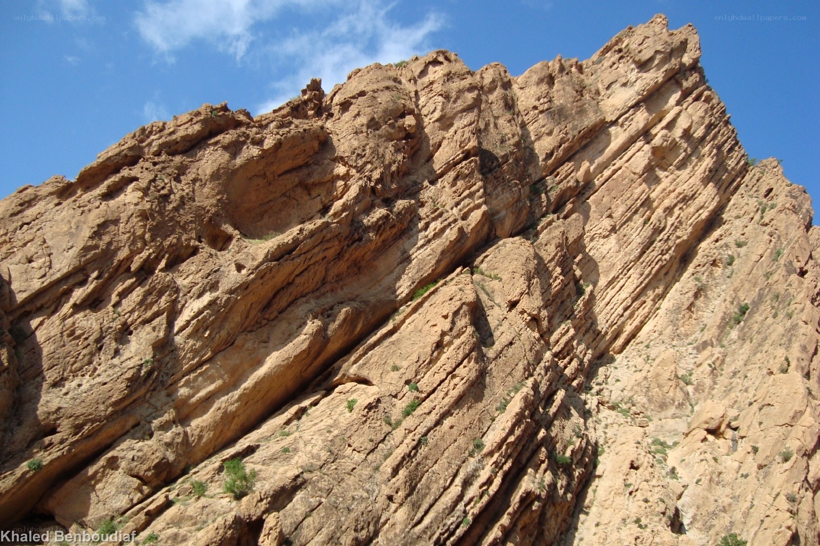 rocky cliff under blue sky