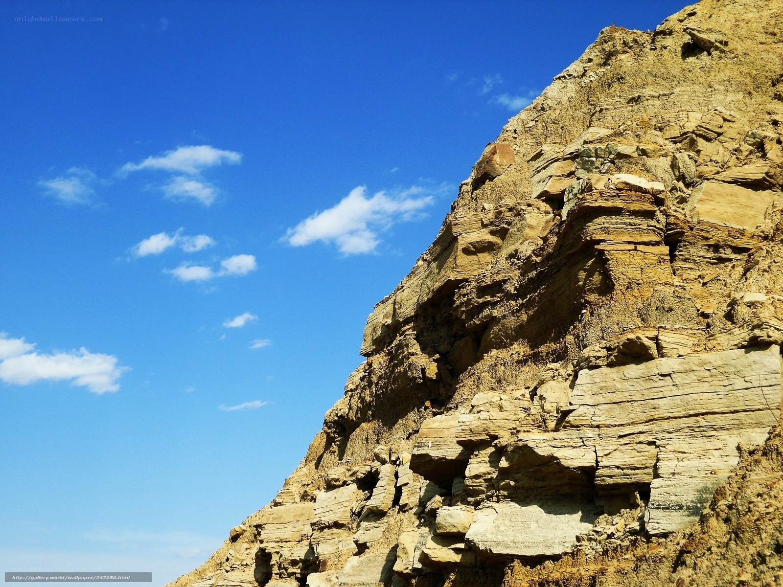 rocky cliff under blue sky