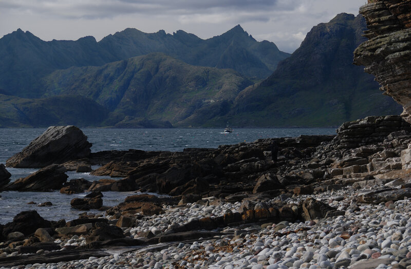 Rocky coast with mountains in background