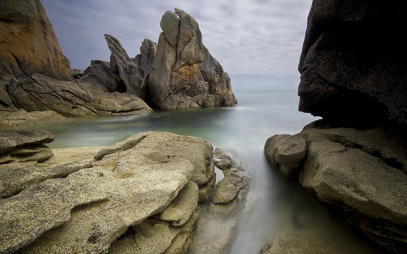 Rocky coastal inlet with smooth water