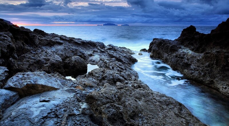 Rocky Coastline at Dusk — Blue, Dramatic, Sunset, Photograph, Ocean, Sky, Island, Gray, Purple