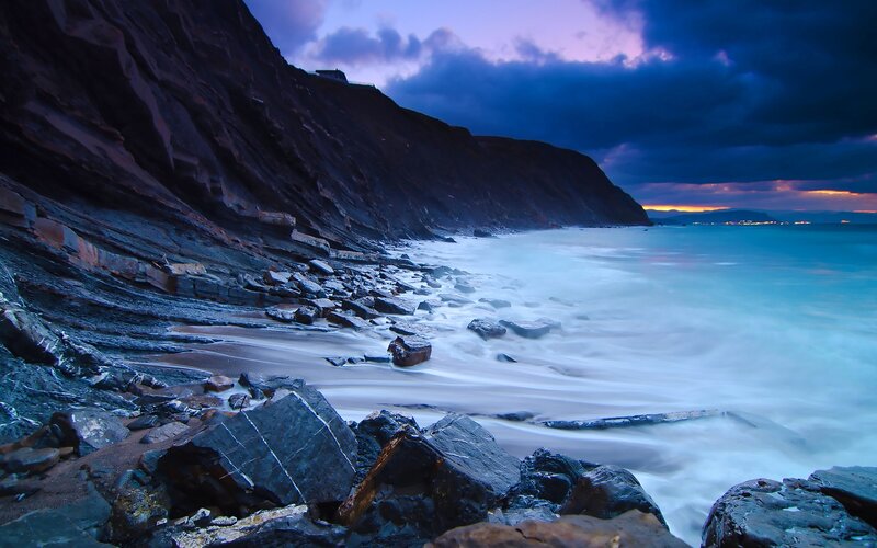 Rocky Coastline at Dusk — Blue, Dramatic, Sunset, Photograph