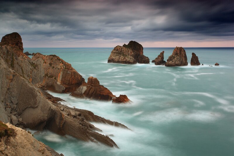 Rocky Coastline at Sea — Blue, Dramatic, Sunset, Photograph, Rocks