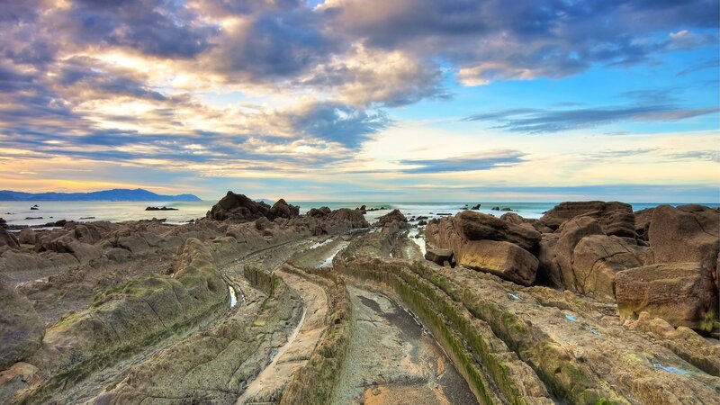Rocky Coastline at Sunset — Blue, Dramatic, Photograph, Rocks, Ocean, Clouds, Mountains