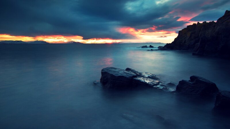 Rocky Coastline at Sunset — Blue, Dramatic, Photograph, Rocks, Sea, Sky, Mountains