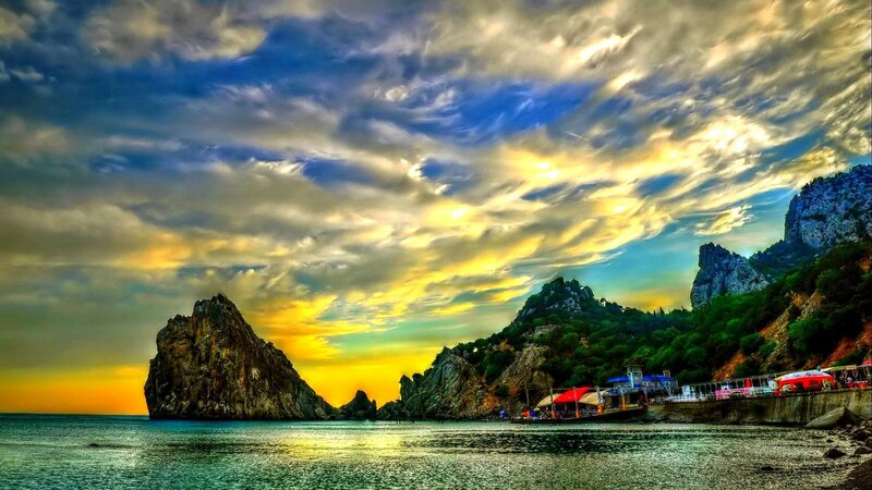 Rocky Coastline at Sunset — Blue, Dramatic, Photograph, Sea, Mountain, Boat, Clouds