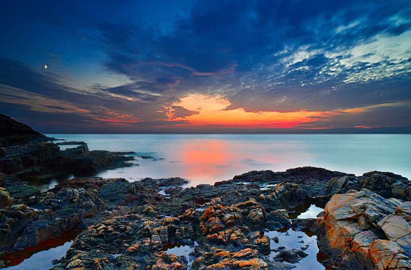 Rocky Coastline at Sunset — Blue, Serene, Photograph, Ocean, Sky, Moon