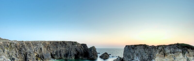 Rocky Coastline at Sunset — Blue, Serene, Photograph, Ocean, Sky, Rocks, Gray