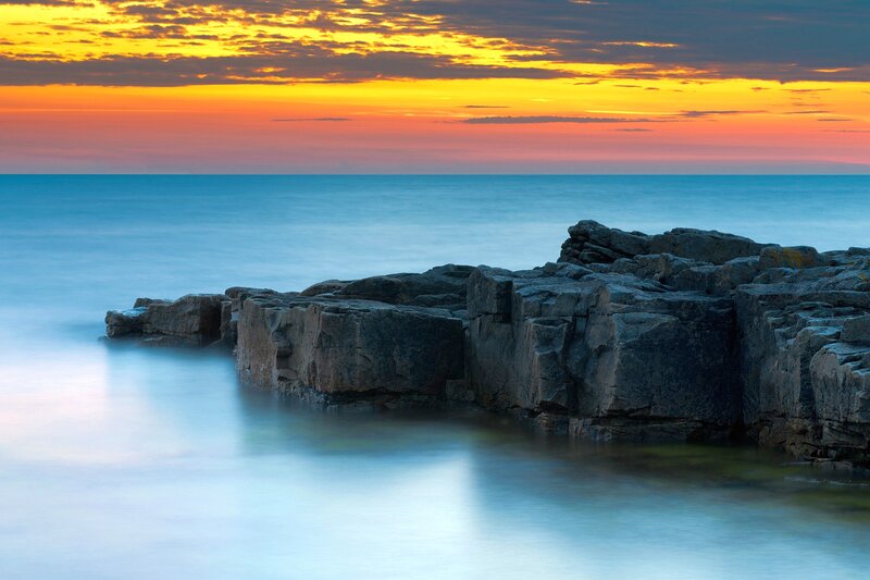 Rocky Coastline at Sunset — Blue, Serene, Photograph, Ocean, Sky, Rocks