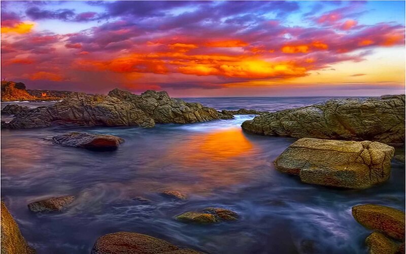 Rocky Coastline at Sunset — Dramatic, Purple