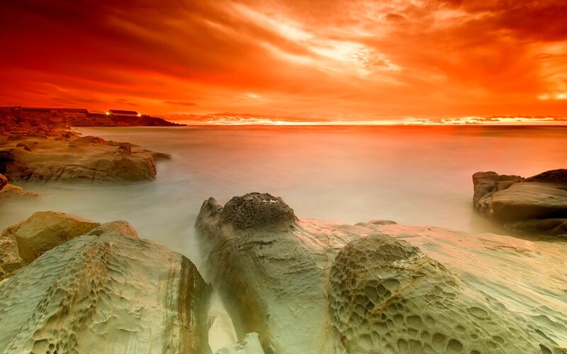 Rocky Coastline at Sunset — Orange, Dramatic, Photograph, Rocks, Ocean, Sky, Lighthouse