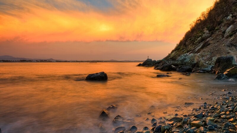 Rocky Coastline at Sunset — Orange, Serene