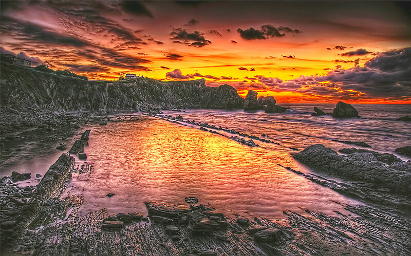 Rocky Coastline at Sunset — Orange