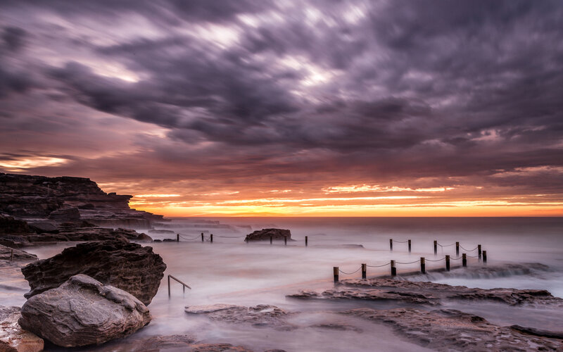 Rocky Coastline at Sunset — Purple, Dramatic, Photograph, Rocks, Ocean, Sky, Pilings