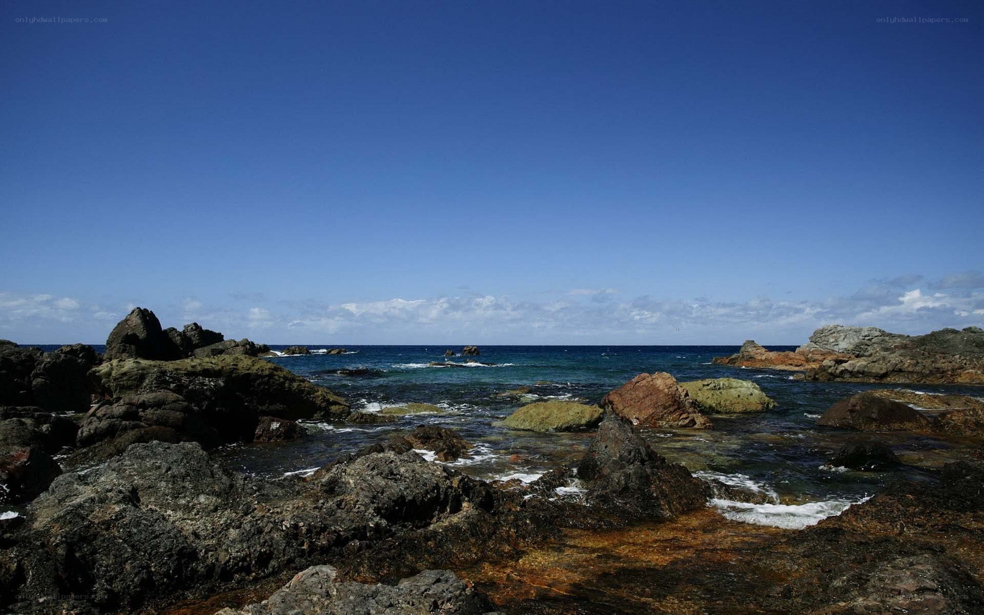 Rocky coastline under blue sky