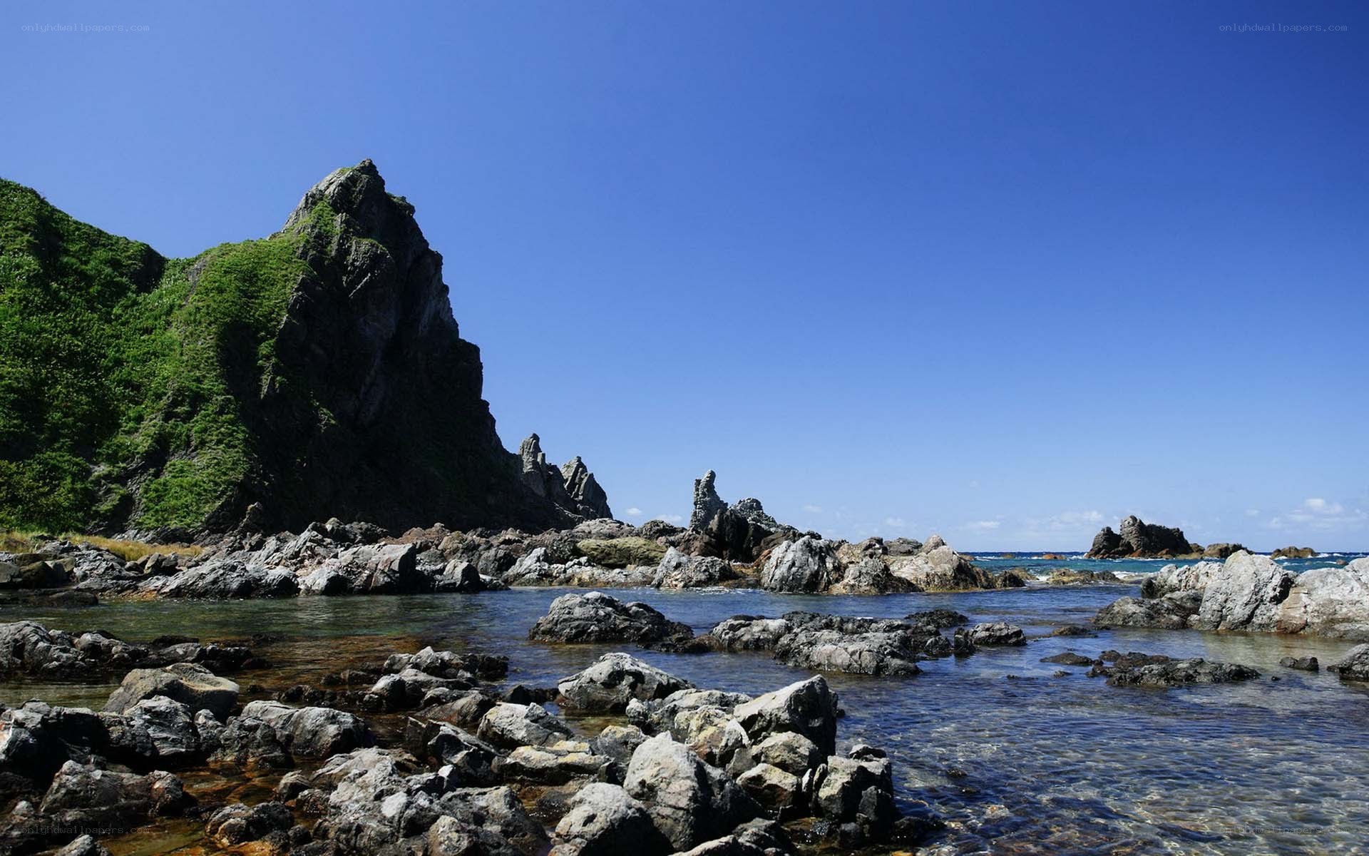 Rocky coastline under blue sky