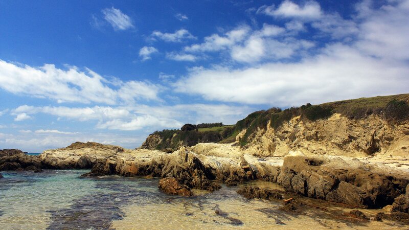 rocky coastline under blue sky