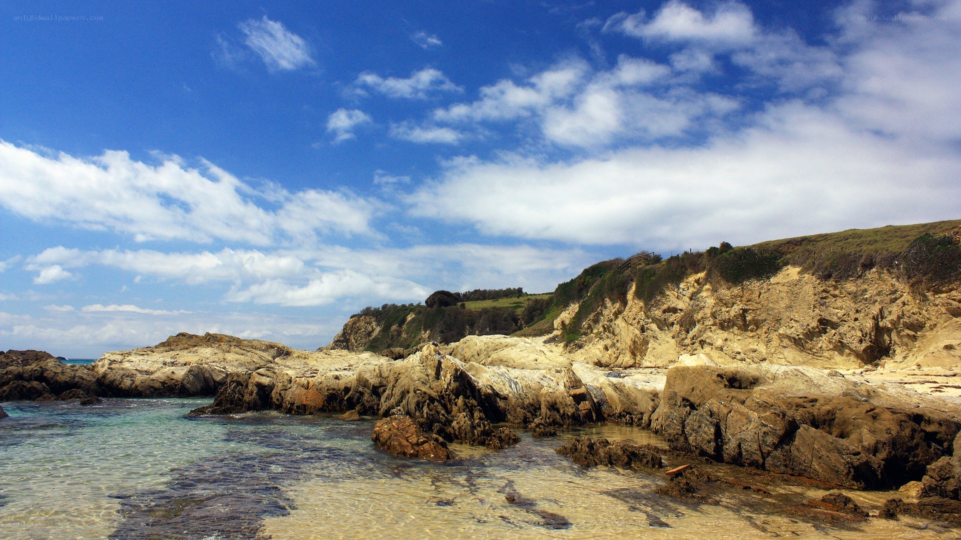 rocky coastline under blue sky