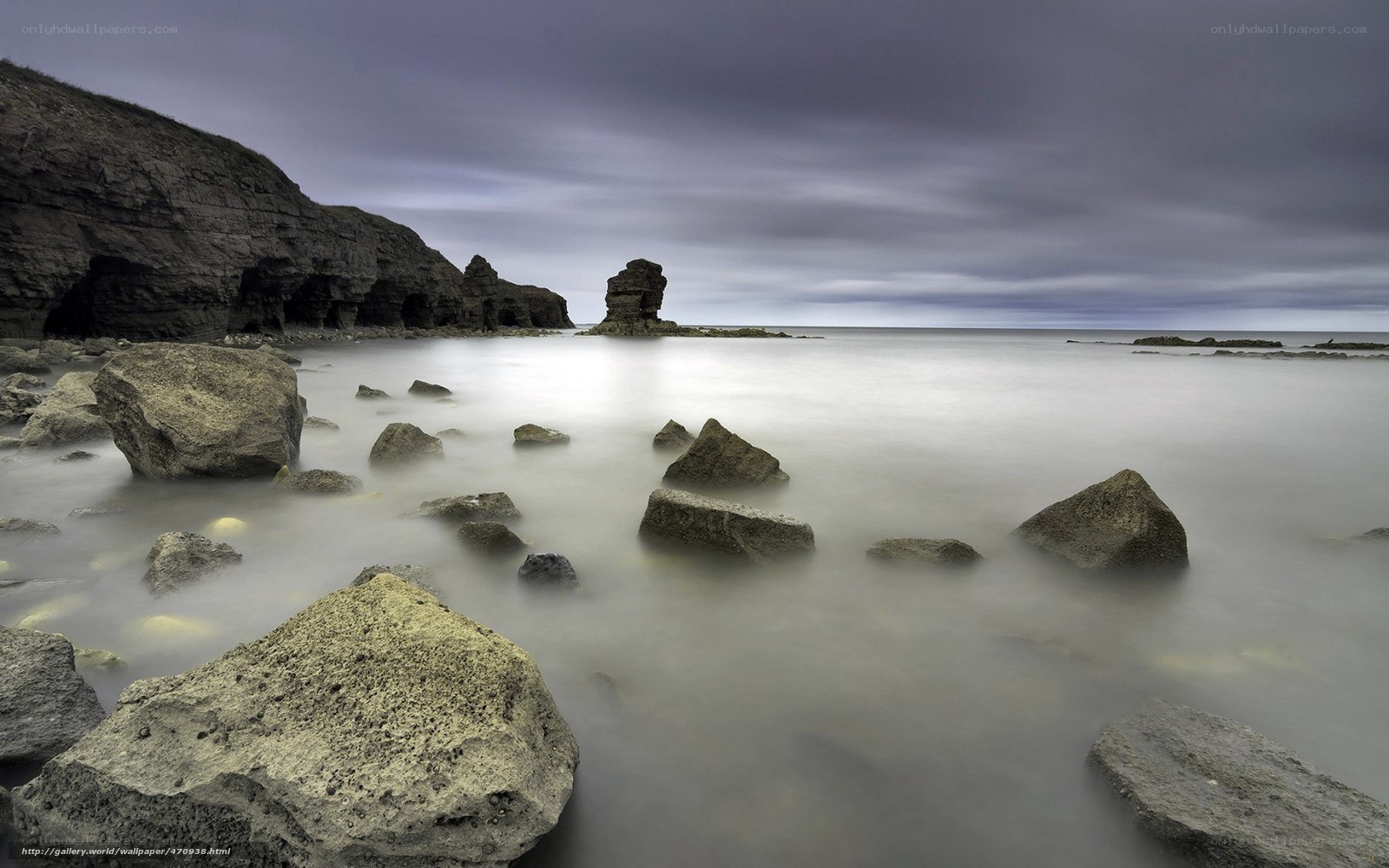 Rocky coastline under cloudy sky