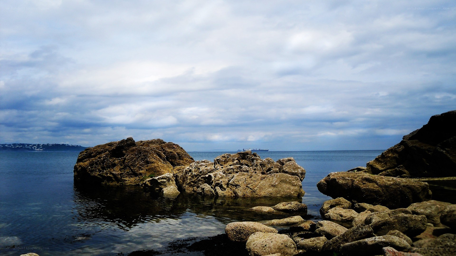 Rocky coastline under cloudy sky