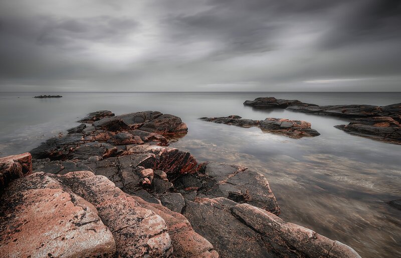 Rocky coastline under cloudy sky