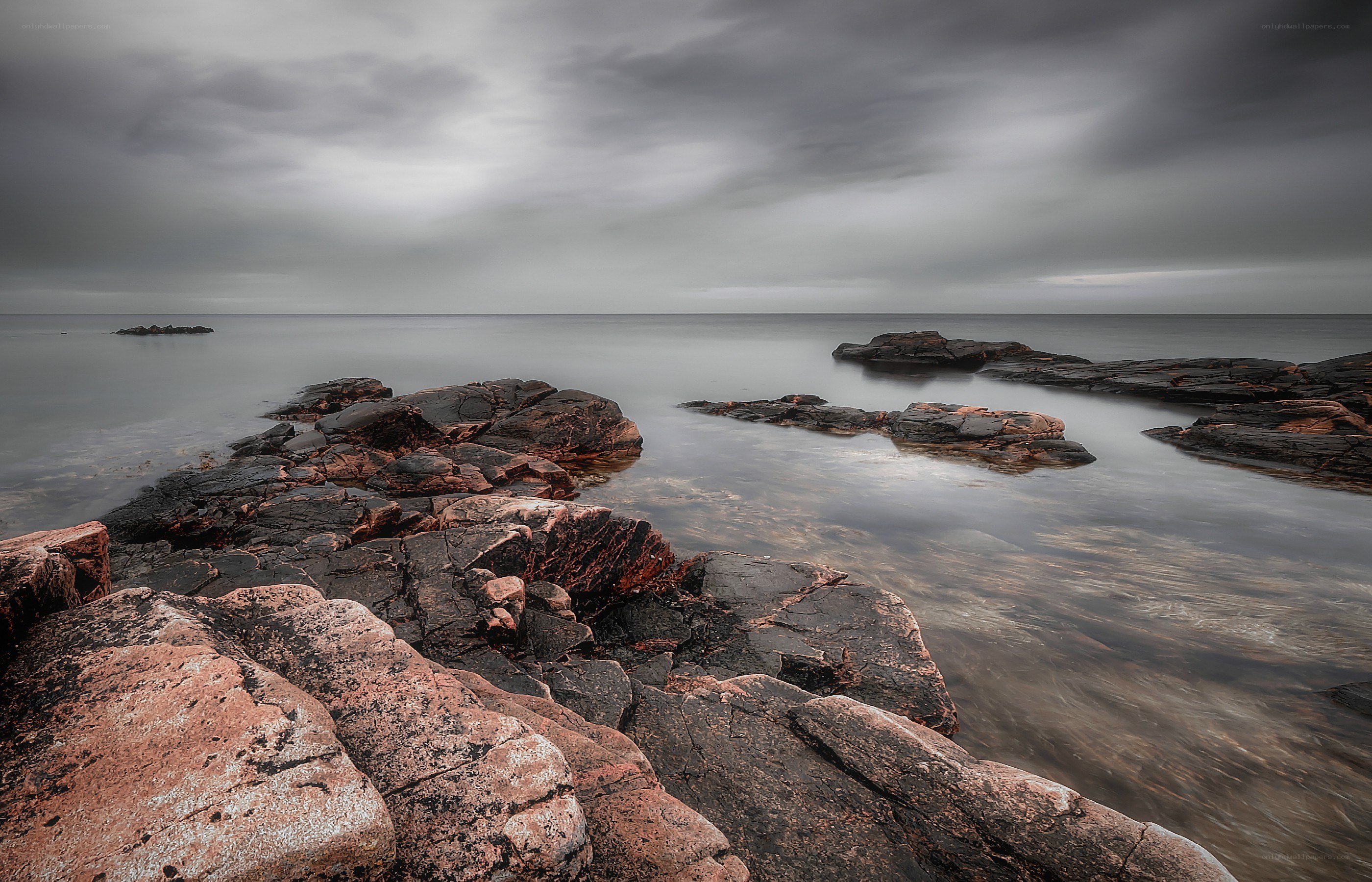 Rocky coastline under cloudy sky