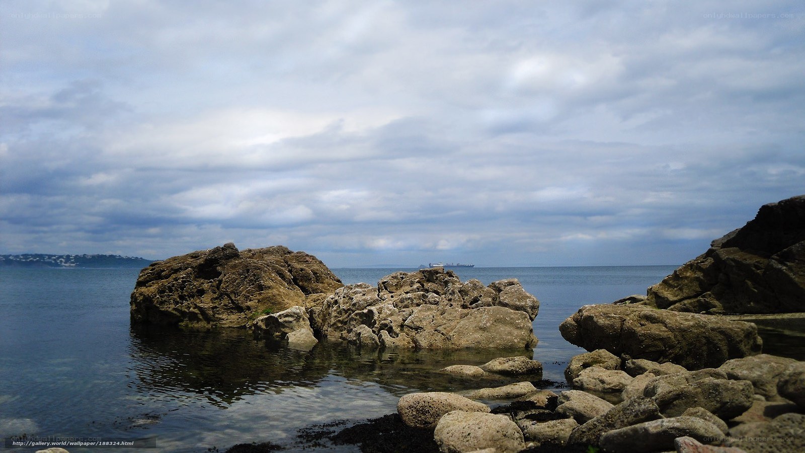 Rocky coastline under cloudy sky