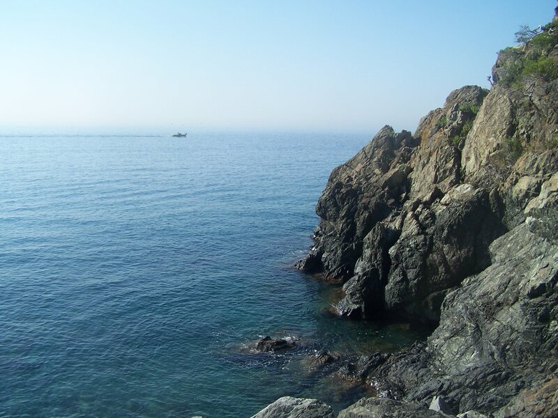 Rocky coastline with boat in distance