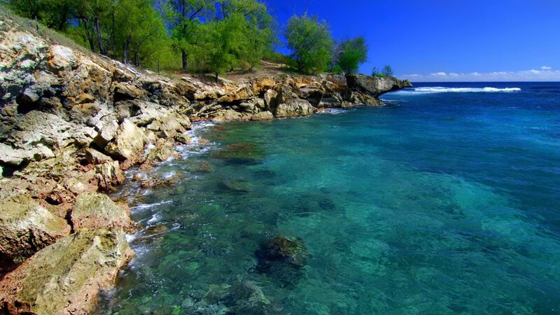 rocky coastline with clear blue water
