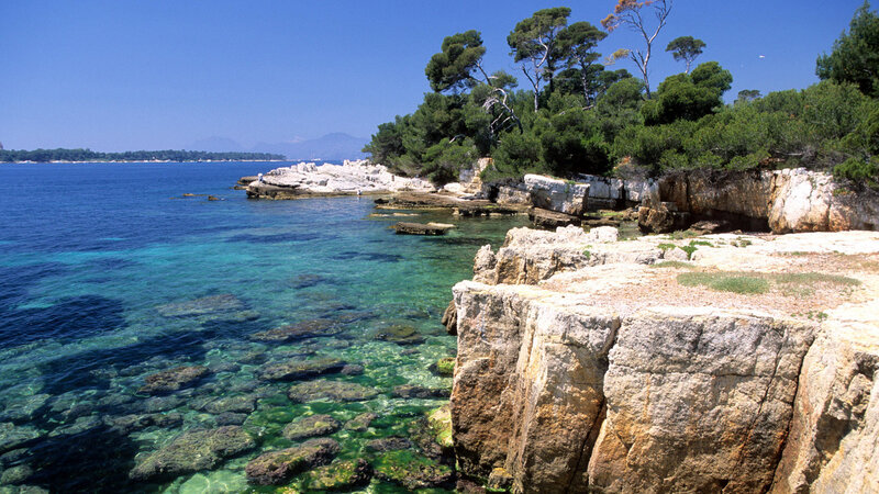 Rocky Coastline with Clear Water — Blue