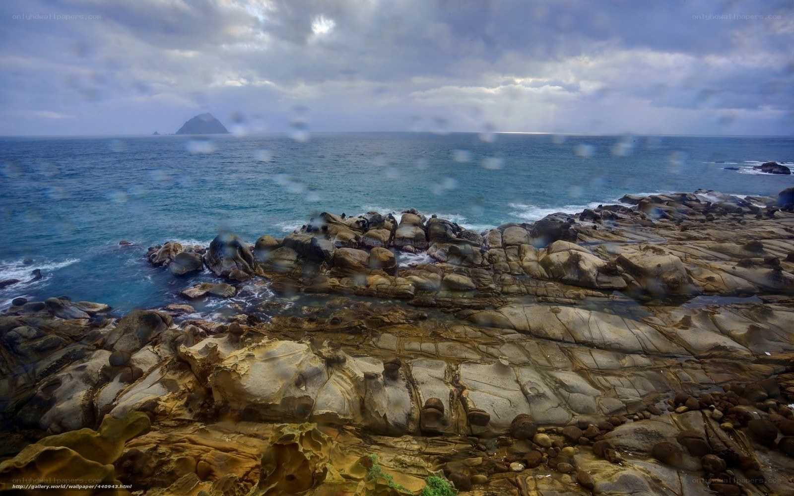 Rocky coastline with distant island