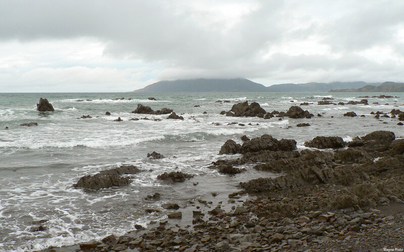 rocky coastline with distant mountains