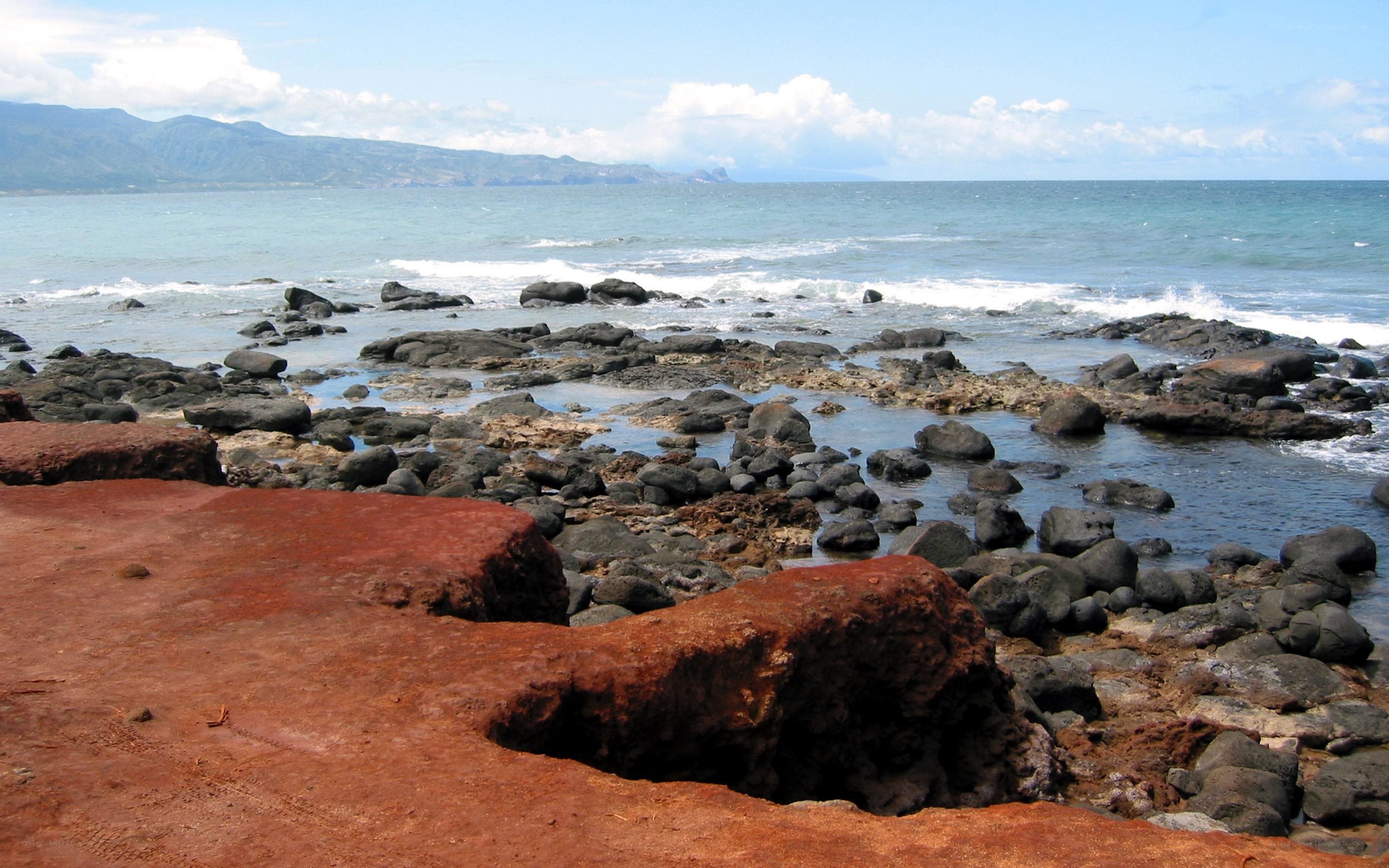 rocky coastline with red sand
