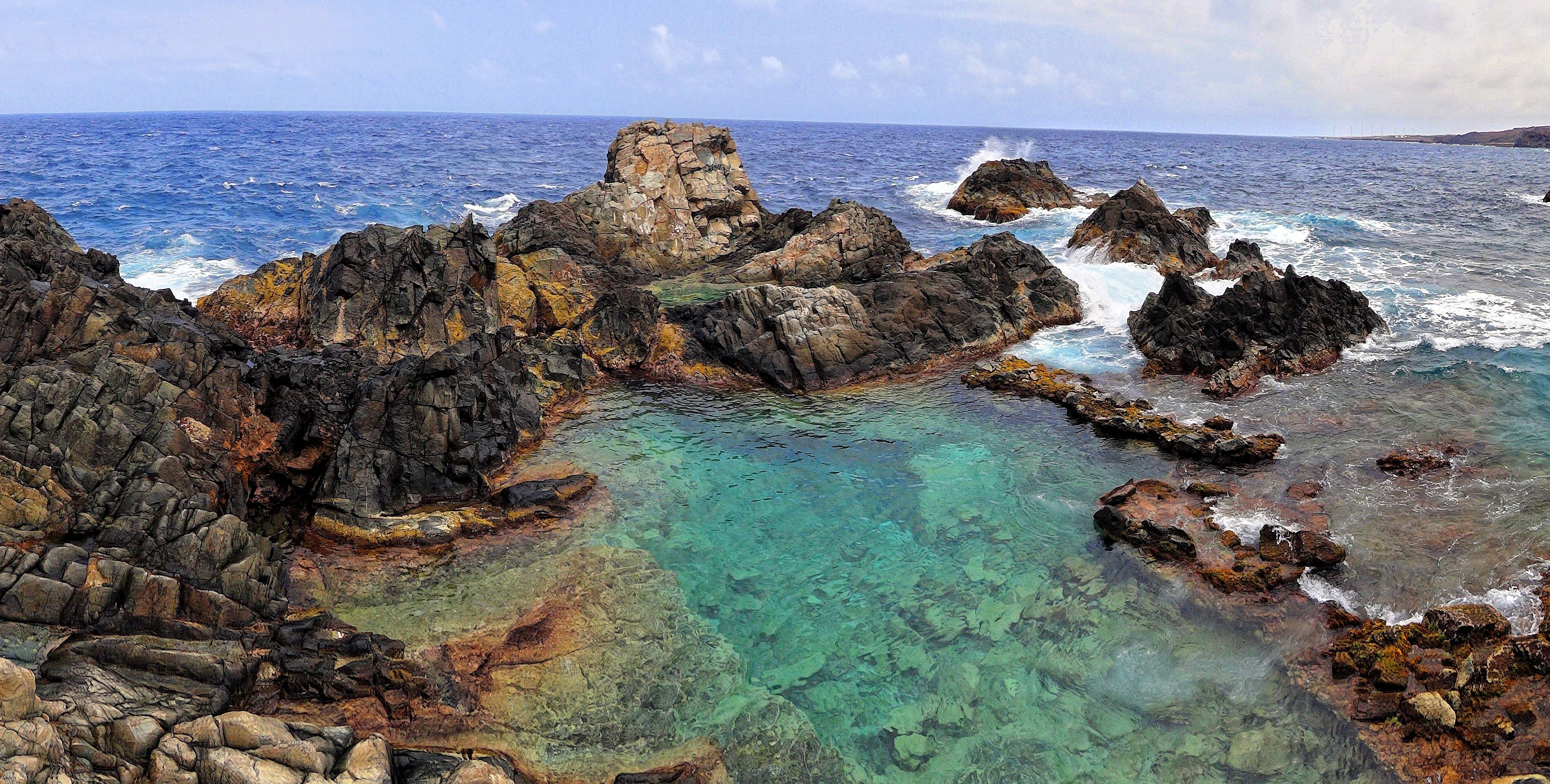 rocky coastline with turquoise pool