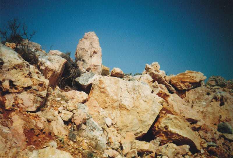 rocky hill under blue sky