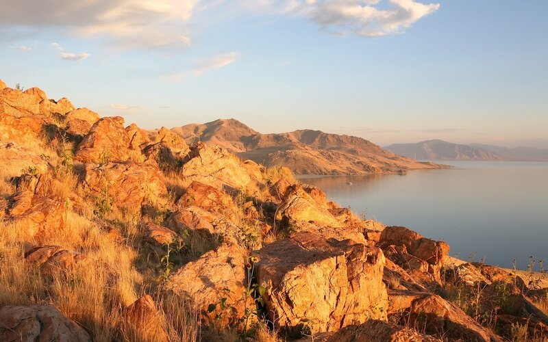 Rocky Hillside by Lake — Orange, Serene
