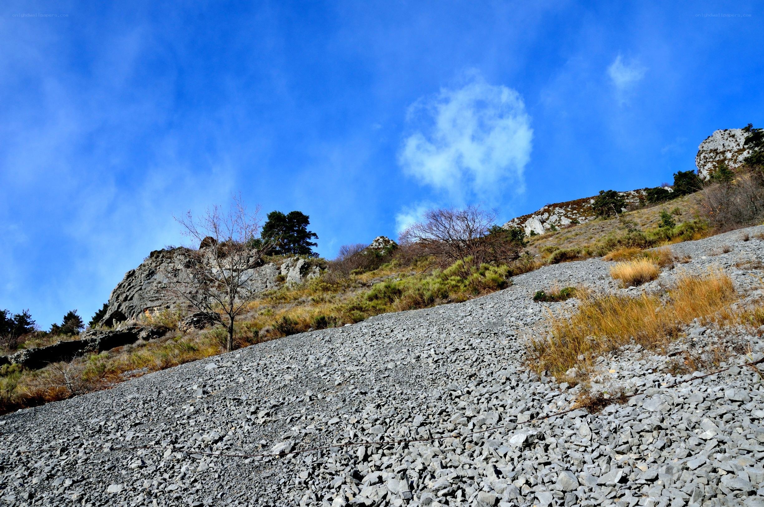 Rocky hillside under blue sky