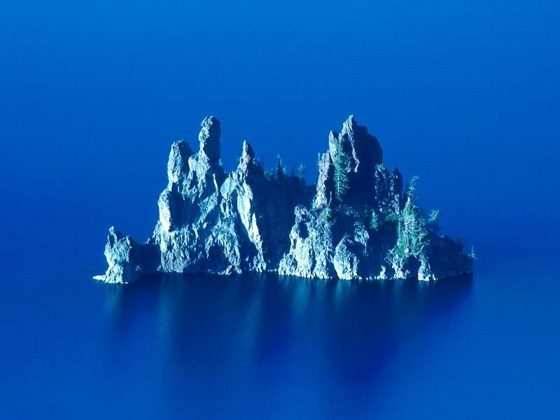 rocky island in blue lake