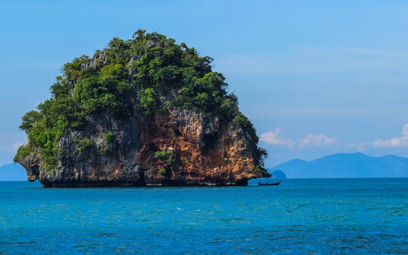 Rocky Island in Ocean — Blue, Serene, Afternoon, Photograph, Boat