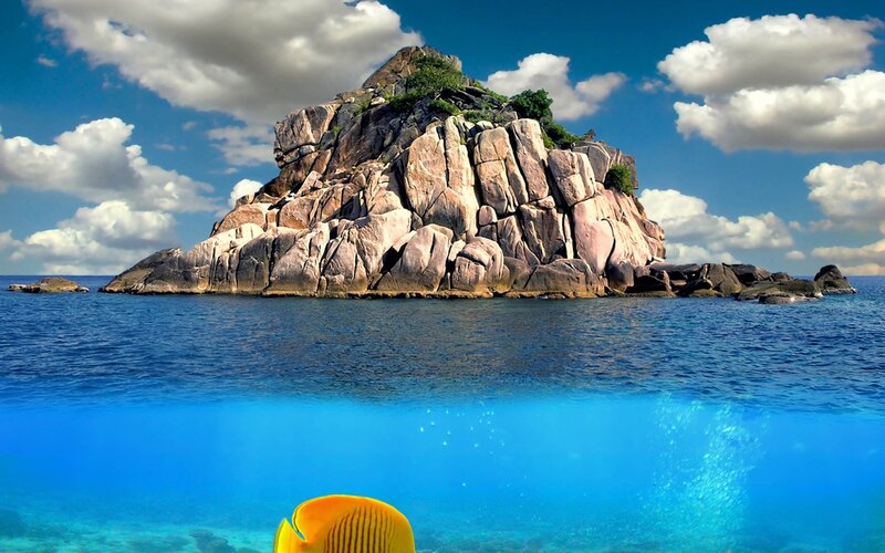 Rocky Island in Ocean — Blue, Serene, Afternoon, Photograph, Fish