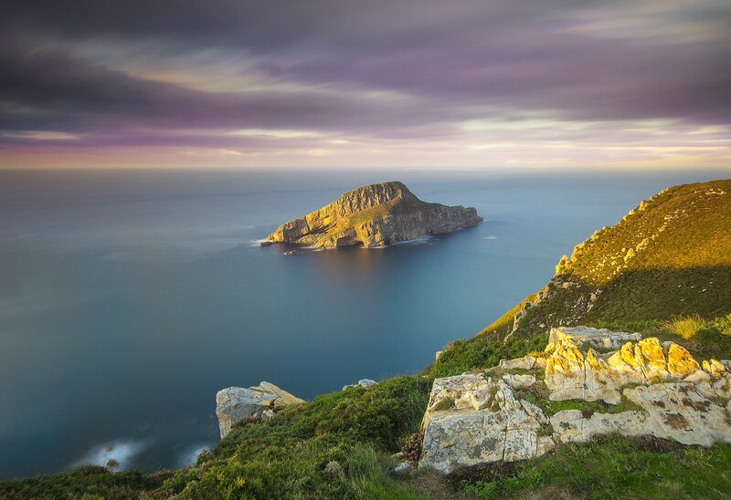 Rocky Island in Ocean — Blue, Serene, Sunset, Photograph