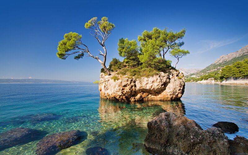 Rocky Island with Trees — Blue, Serene, Afternoon, Photograph, Sea