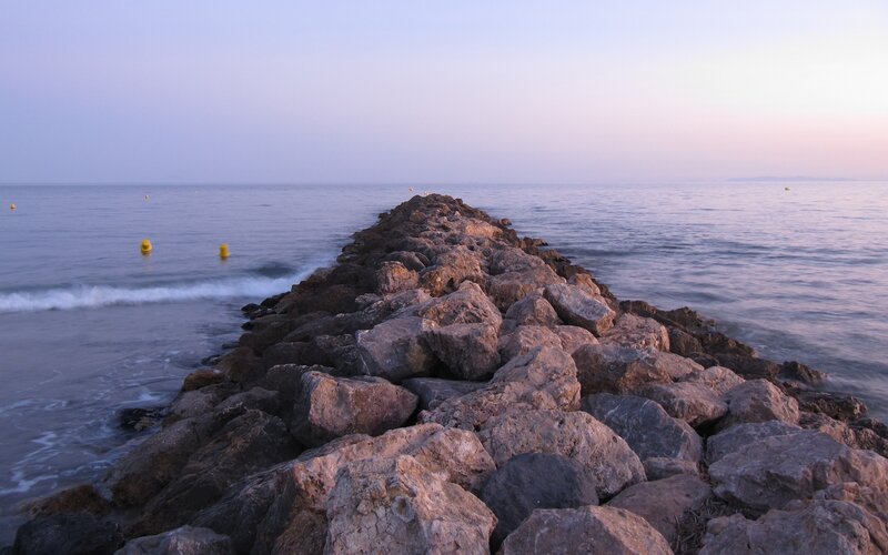 Rocky Jetty at Sunset — Blue, Serene, Photograph