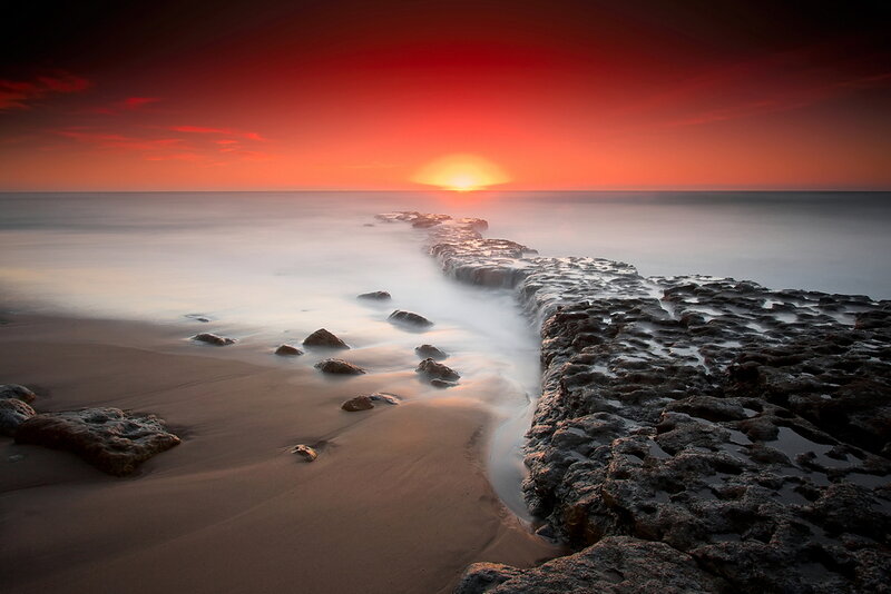 Rocky Jetty at Sunset — Red