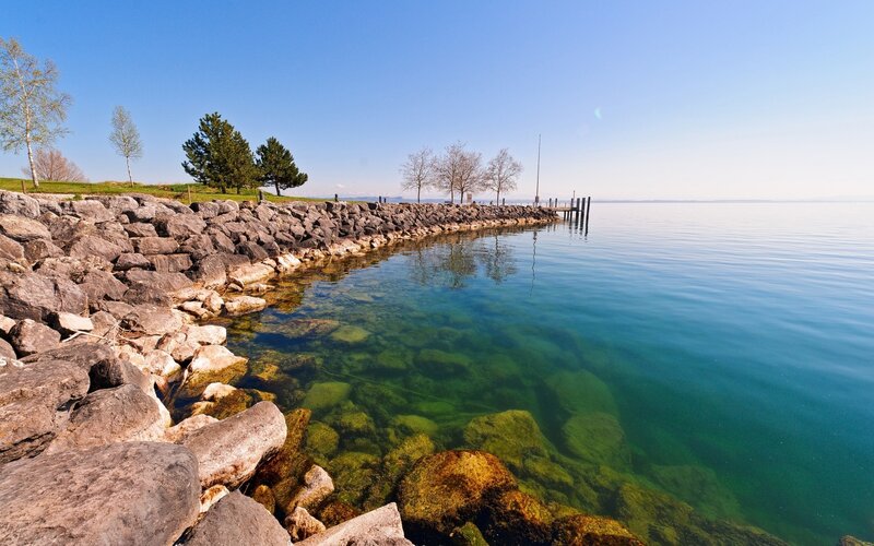 Rocky Lakeshore with Pier — Blue