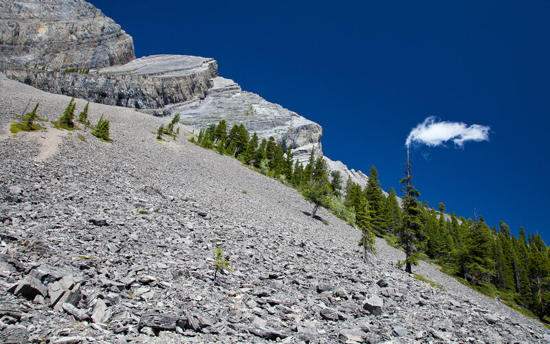 Rocky mountain slope under blue sky