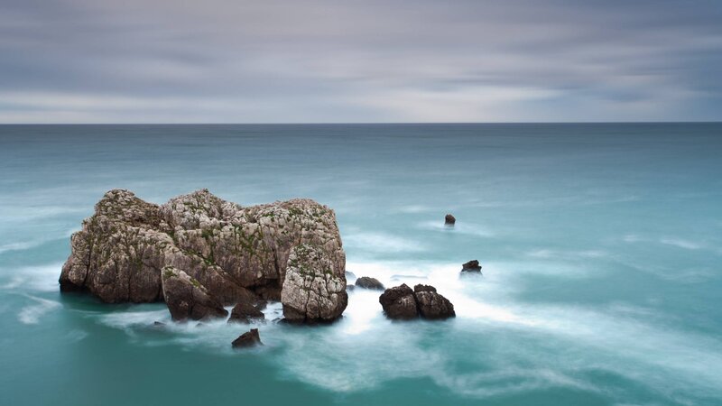 Rocky Outcrop in Ocean — Blue